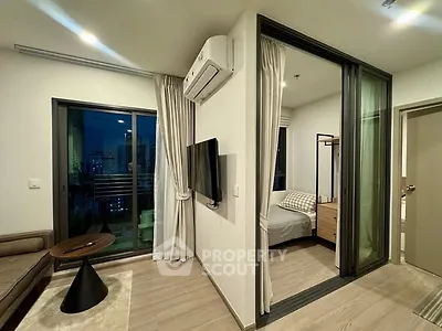 Modern apartment interior with cozy living room and bedroom, featuring sleek furniture and city view balcony.