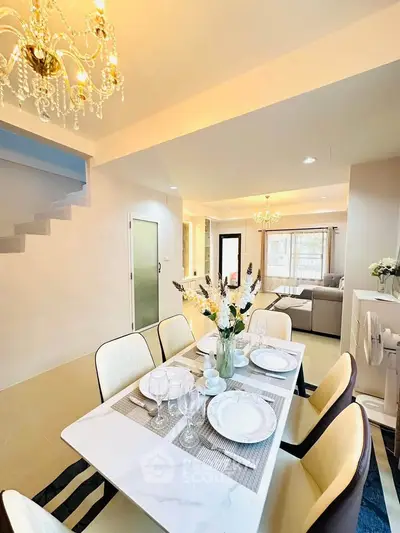 Elegant dining area with chandelier and modern decor in a spacious living room