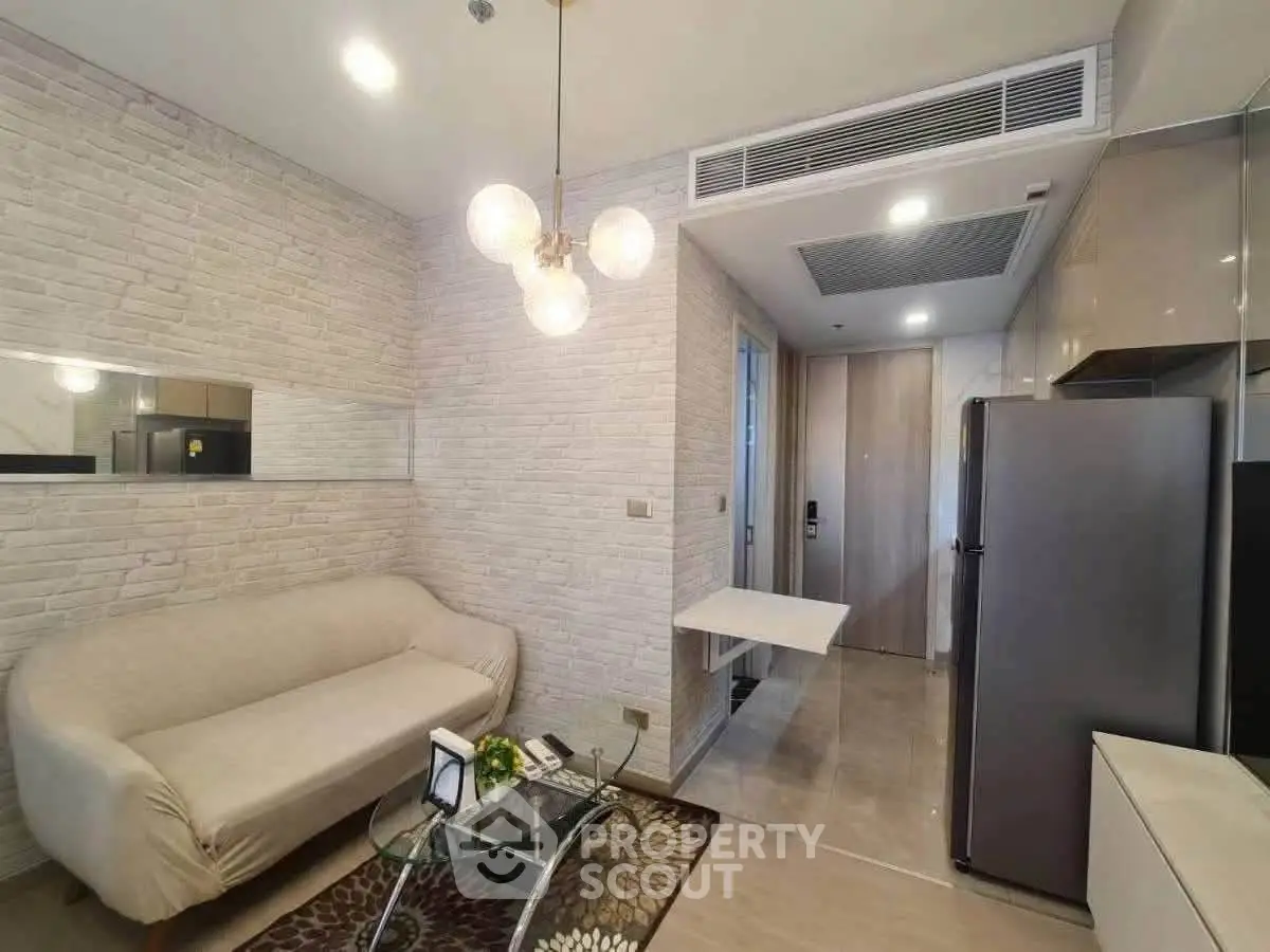 Modern living room with stylish sofa and open kitchen layout in a contemporary apartment.
