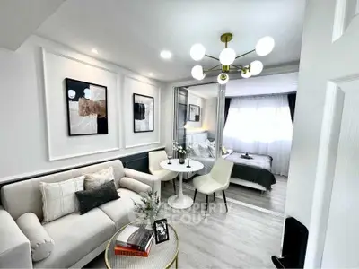 Modern open-concept living room with elegant decor and cozy seating area.