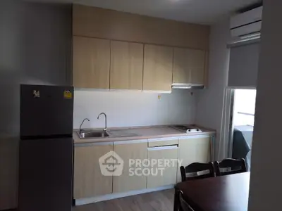 Modern kitchen with sleek cabinetry and compact design perfect for urban living.