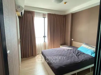 Cozy bedroom with natural light and modern decor in a stylish apartment.