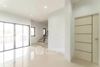 Spacious modern interior with sleek staircase and large windows