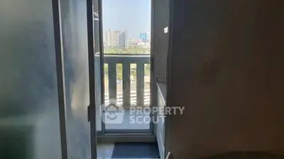 City view from a balcony with partial interior glimpse