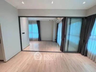 Spacious modern living room with sliding glass doors and elegant curtains