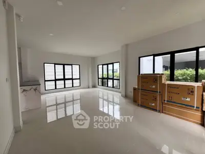 Spacious modern living room with large windows and sleek flooring
