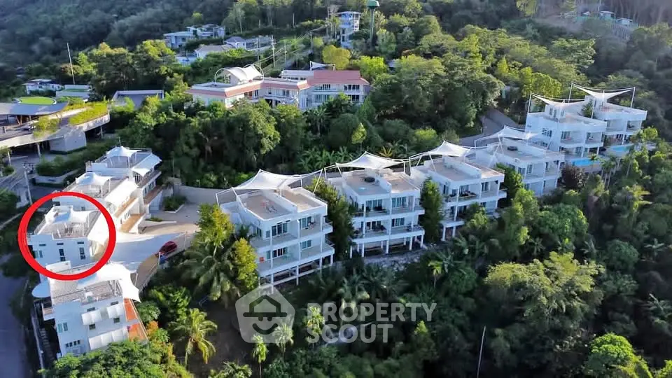 Stunning aerial view of luxury hillside villas surrounded by lush greenery, offering a serene and exclusive living experience.