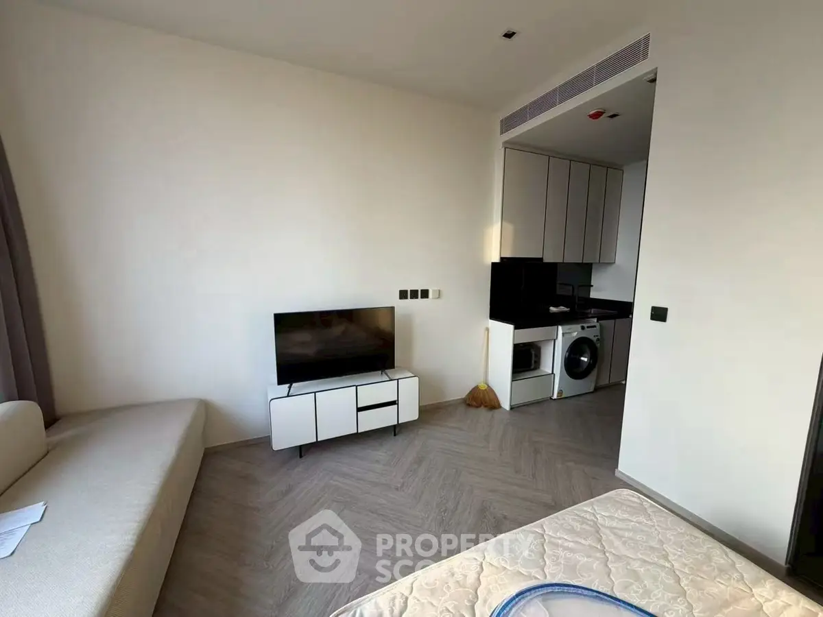 Modern studio apartment with sleek kitchen and cozy living area