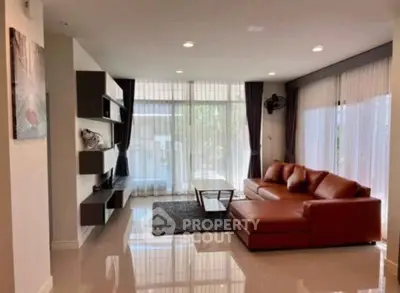 Spacious modern living room with large windows and stylish furniture