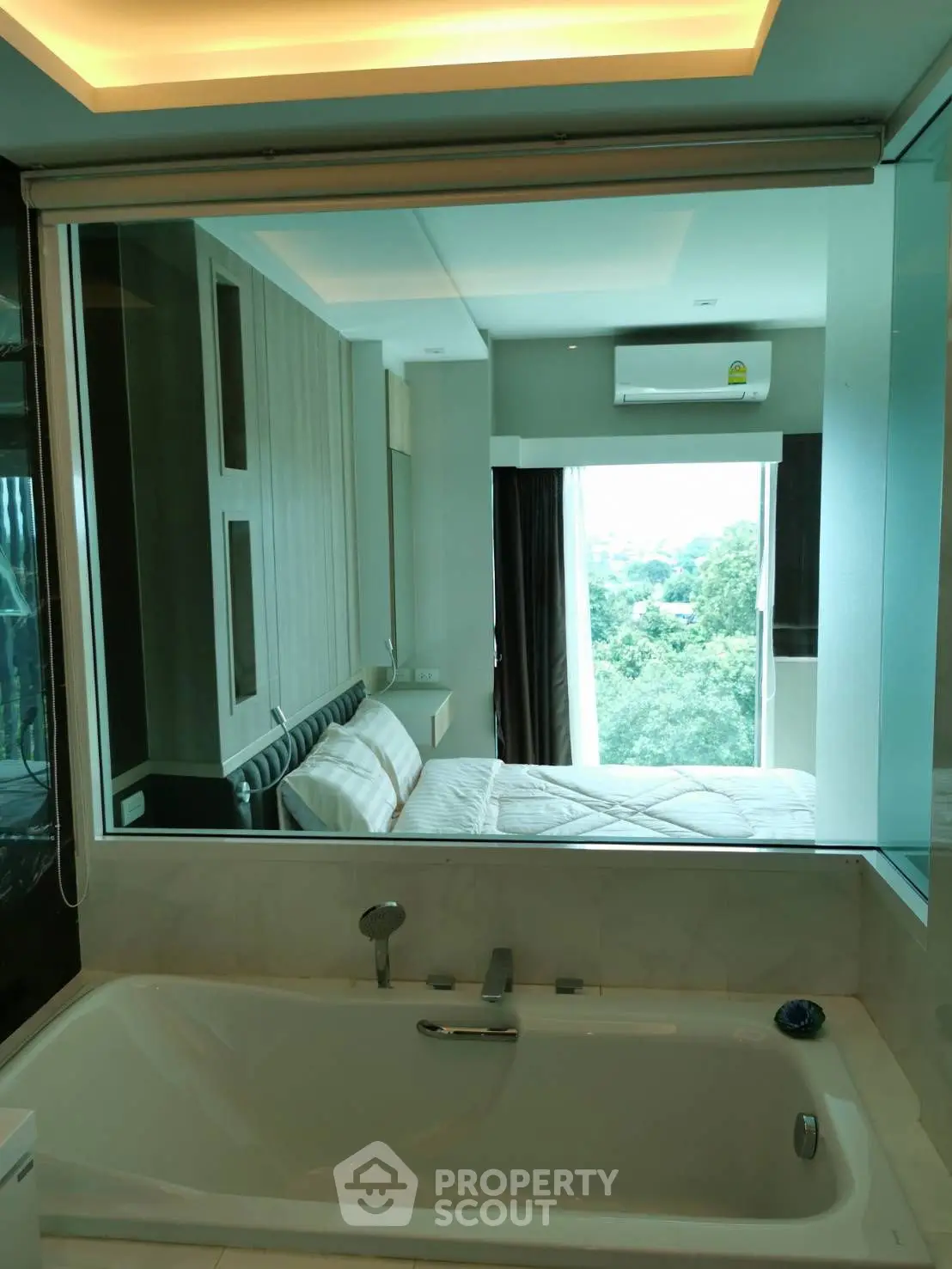 Luxurious bathroom with bathtub and scenic bedroom view
