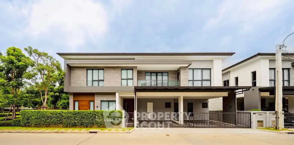 Modern two-story house with sleek design and spacious driveway in a serene neighborhood.