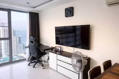 Modern living room with stunning city view, sleek furniture, and large TV setup.