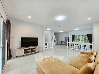 Spacious living room with modern decor and large windows for natural light