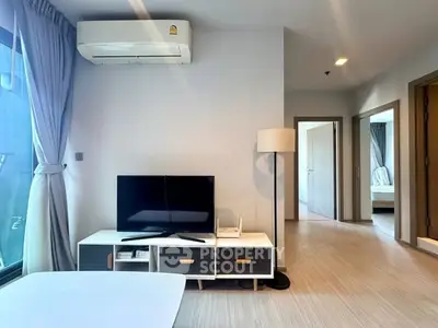 Modern living room with TV, air conditioning, and stylish decor in a bright apartment.