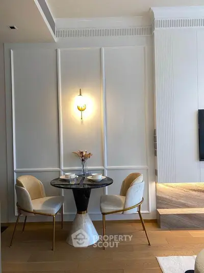Elegant dining nook with modern chairs and marble table in stylish living space.