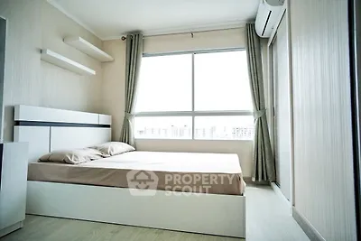 Bright and modern bedroom with large window and minimalist design.