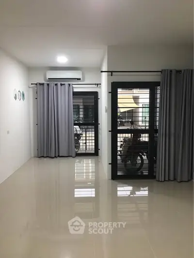 Spacious living room with modern design and large windows for natural light.