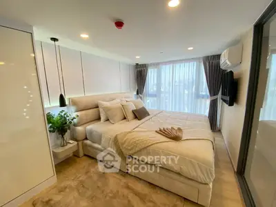 Luxurious modern bedroom with elegant decor and large windows for natural light.