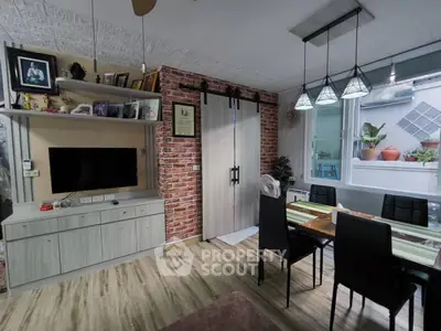 Charming living room with rustic brick wall and modern dining area