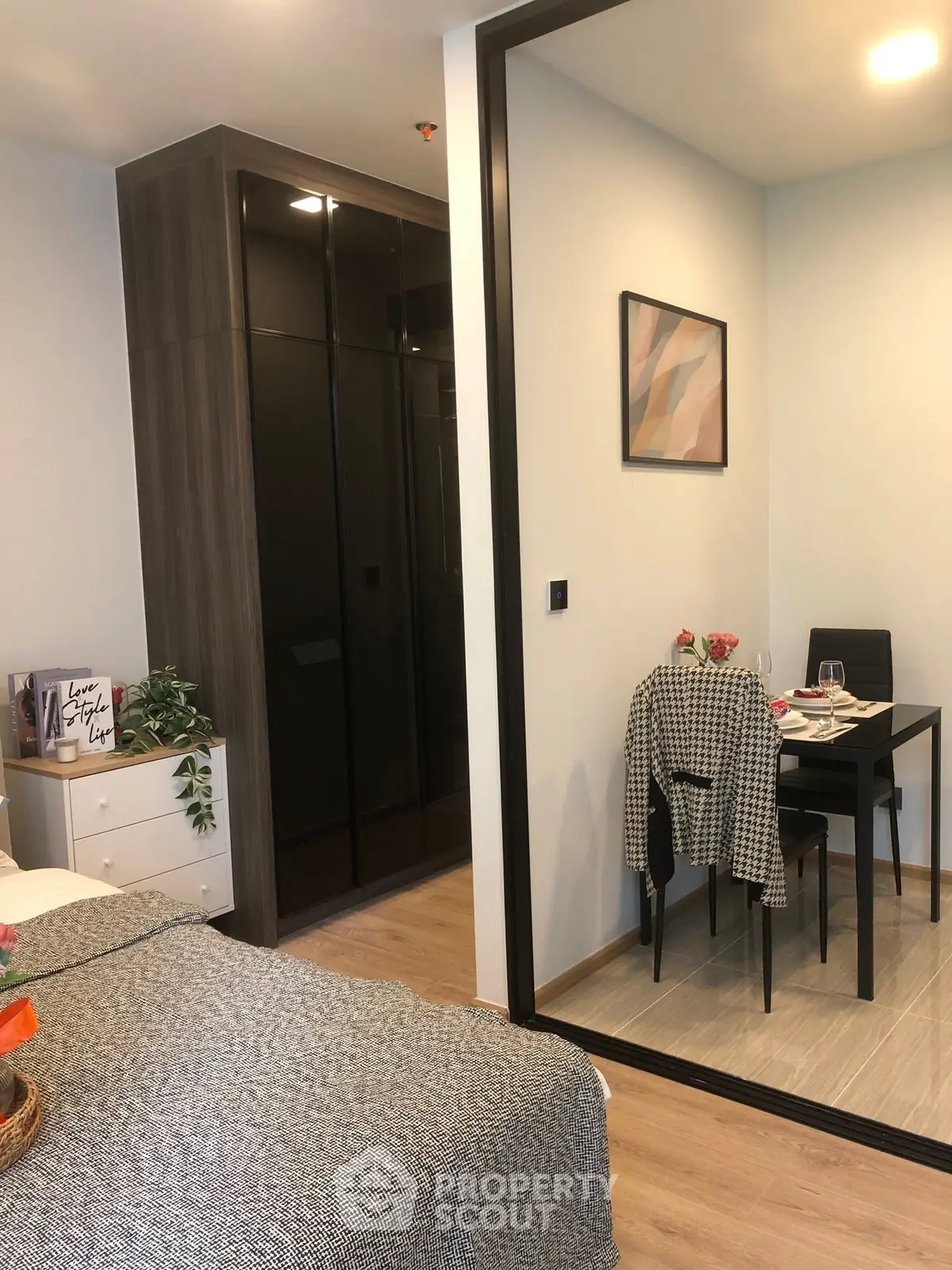 Cozy bedroom with modern decor and small dining area, perfect for urban living.