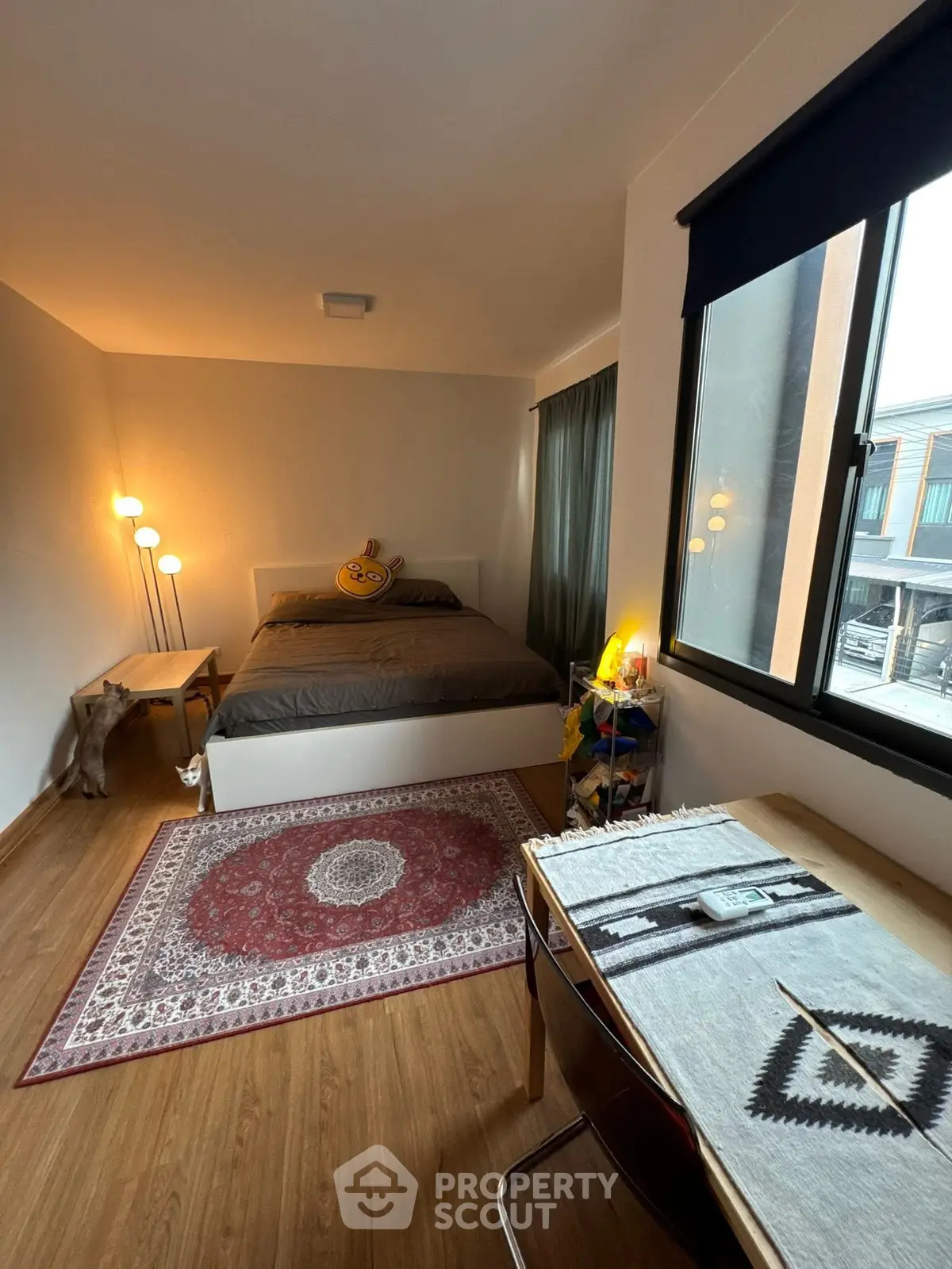 Cozy bedroom with modern decor and large window view