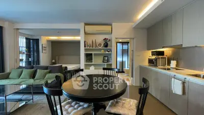 Modern open-plan living and kitchen area with stylish decor and cozy ambiance.