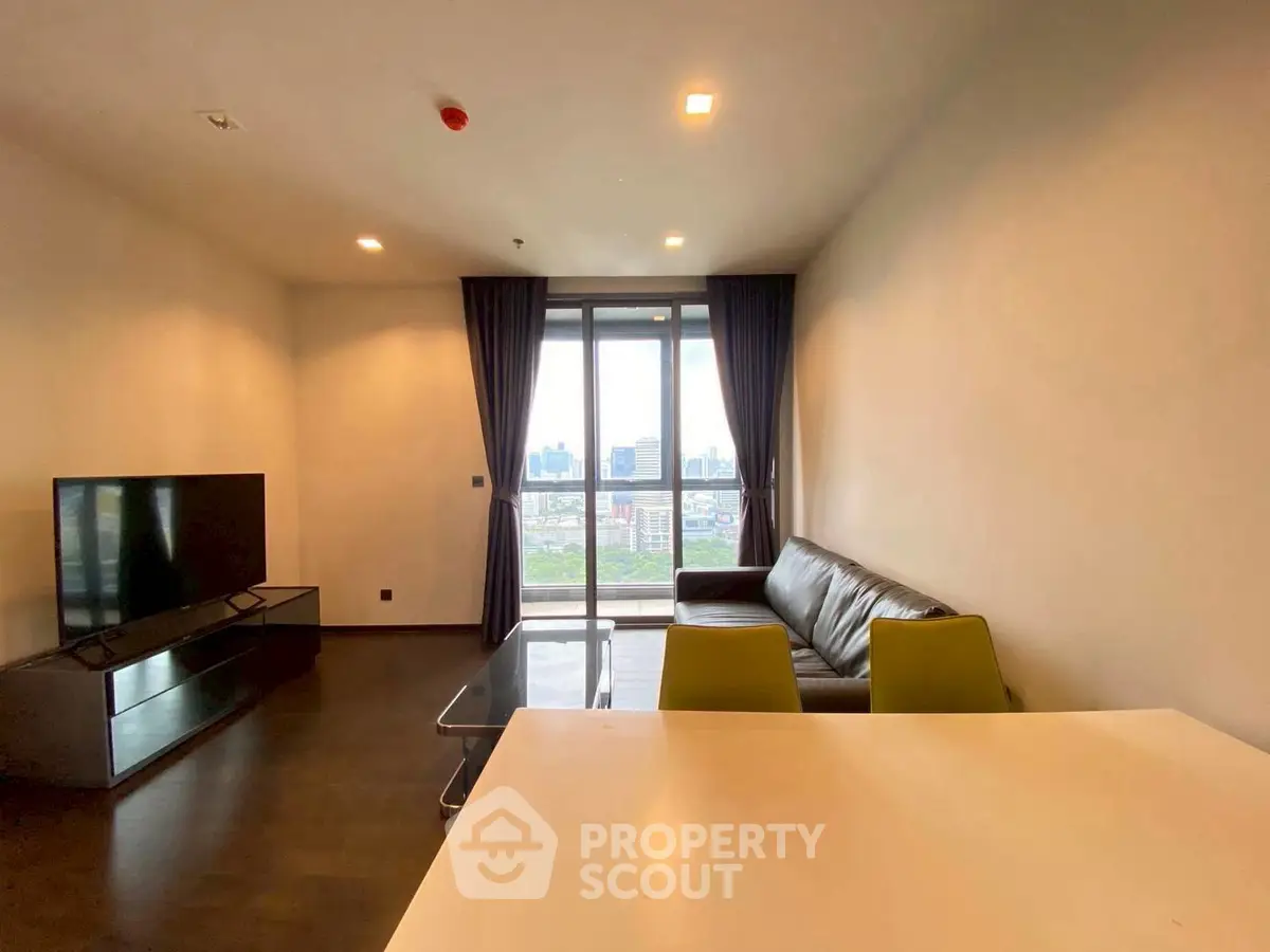 Modern living room with city view, sleek furniture, and large windows for natural light.