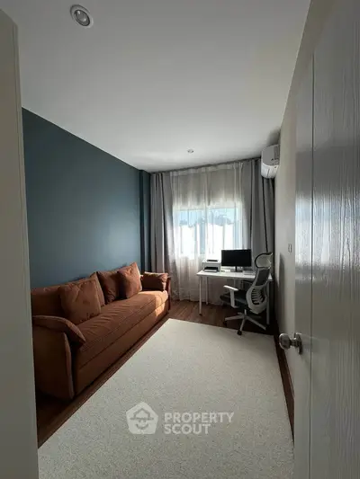 Modern study room with cozy sofa and sleek desk setup