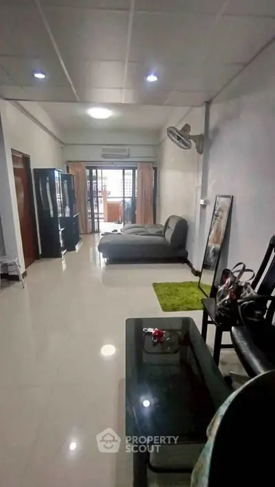 Spacious living room with modern decor and balcony access