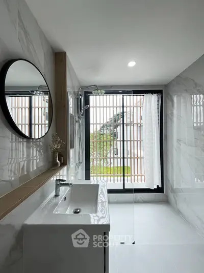 Modern bathroom with sleek design and large window for natural light.