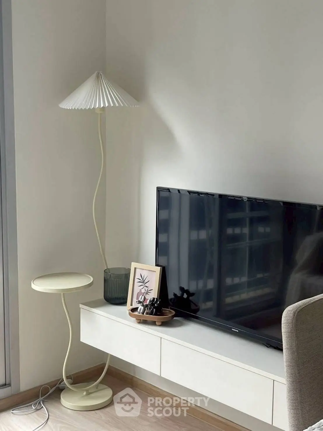 Modern living room with stylish lamp and TV setup on sleek console.