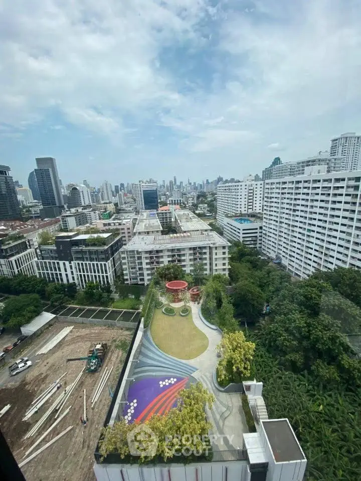 Stunning cityscape view from high-rise building showcasing urban skyline and lush greenery.