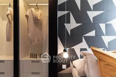 Modern bedroom with geometric wall design and stylish wardrobe