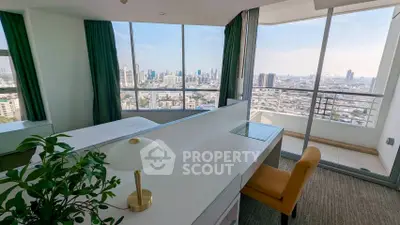 Spacious bedroom with stunning city view and private balcony in modern high-rise apartment.
