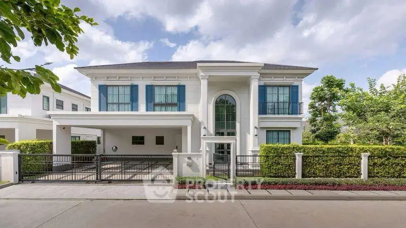Elegant two-story house with modern architecture and lush greenery, perfect for luxury living.