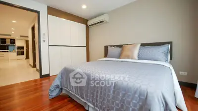 Spacious modern bedroom with elegant decor and wooden flooring