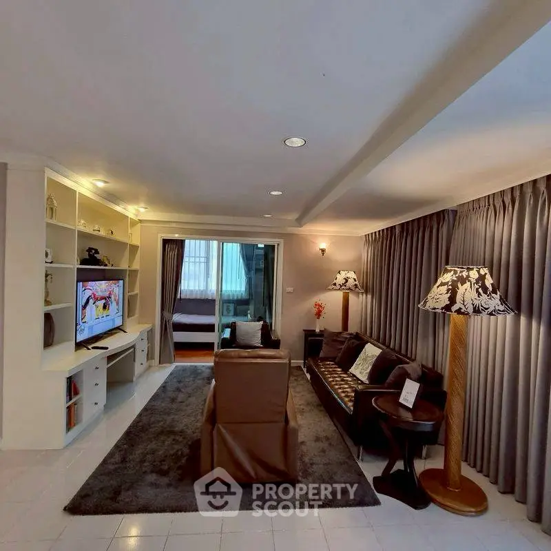 Spacious living room with elegant decor and cozy seating area, perfect for relaxation and entertainment.