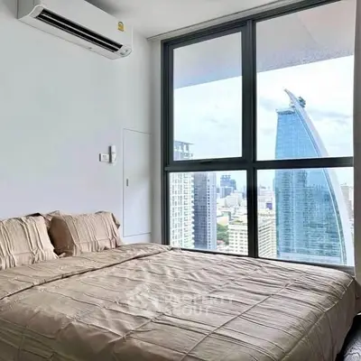 Modern bedroom with city view and large windows in high-rise apartment