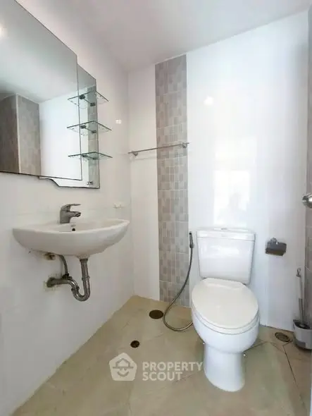Modern bathroom with sleek fixtures and neutral tiles, perfect for a contemporary home.