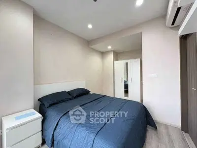 Modern bedroom with sleek design and cozy ambiance, featuring a comfortable bed and stylish decor.