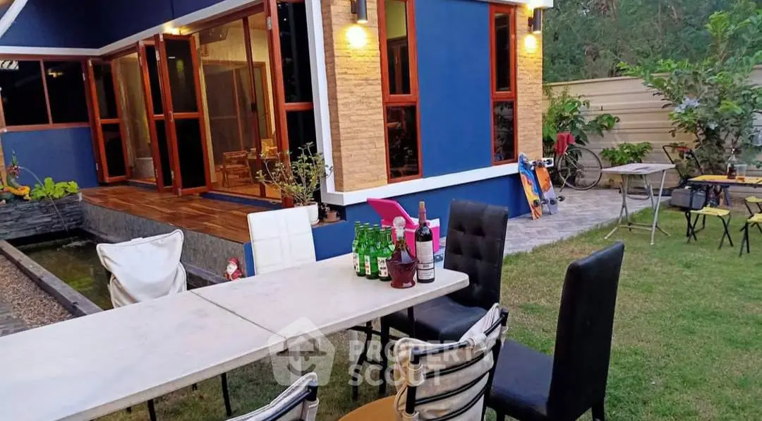 Charming backyard with patio seating and lush garden, perfect for outdoor gatherings.