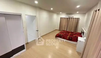 Spacious bedroom with modern decor and ample natural light