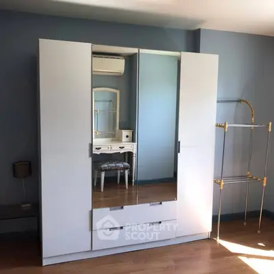 Spacious bedroom with modern wardrobe and elegant vanity set