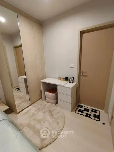 Cozy bedroom with mirrored wardrobe and modern decor