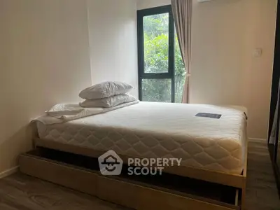 Cozy bedroom with natural light and modern furnishings in a serene setting.