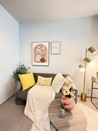 Chic living room with modern decor, cozy sofa, stylish lighting, and elegant wall art.