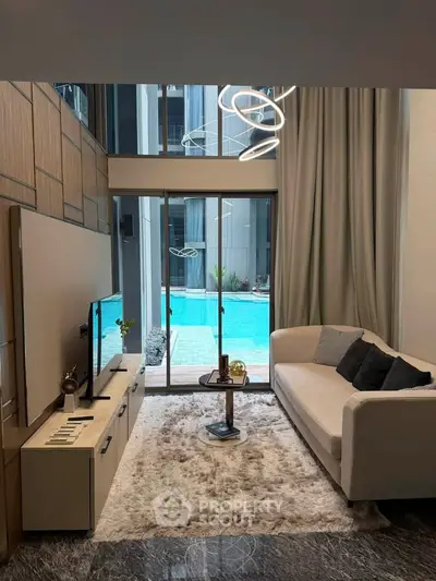 Luxurious living room with pool view, modern decor, and elegant lighting in a high-end apartment.