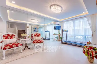 Luxurious living room with elegant decor and modern treadmill, perfect for stylish home fitness.