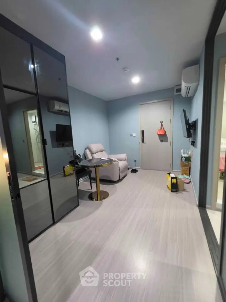Modern living room with sleek design and comfortable seating in a stylish apartment.