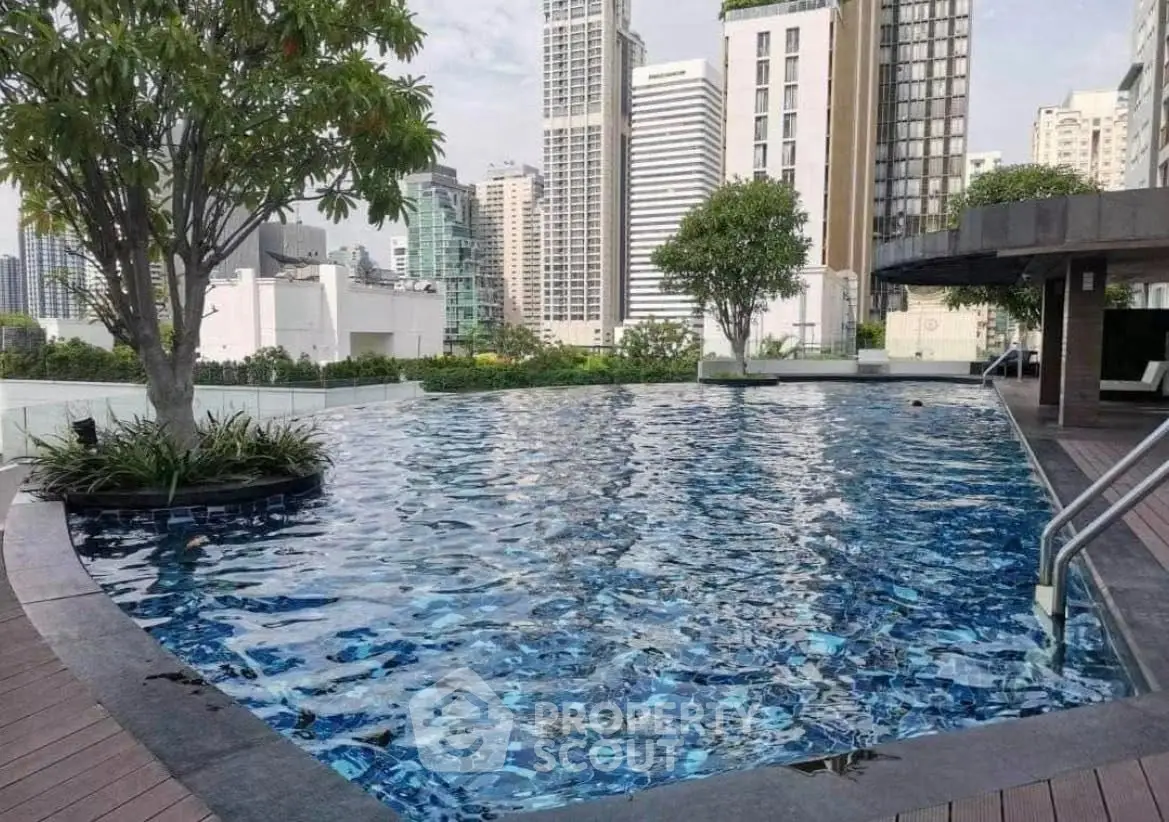 Luxurious rooftop pool with stunning city skyline views in modern high-rise building.